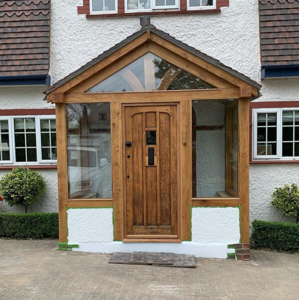 An image of a refurbished front porch with glass windows